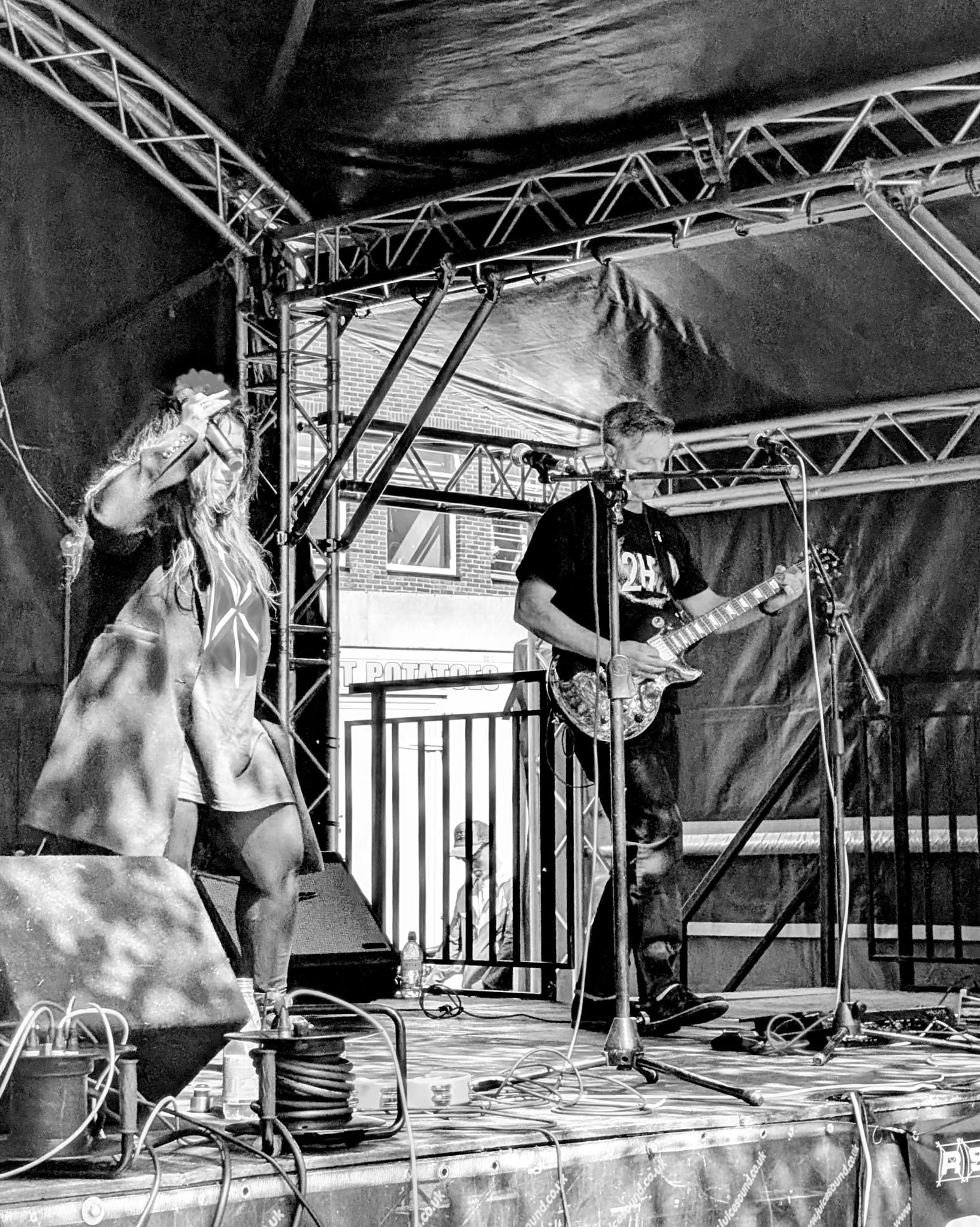 2HD vocalist and guitarist performing in black and white